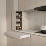 White pull out counter extension in a modern minimalist kitchen with open pantry.
